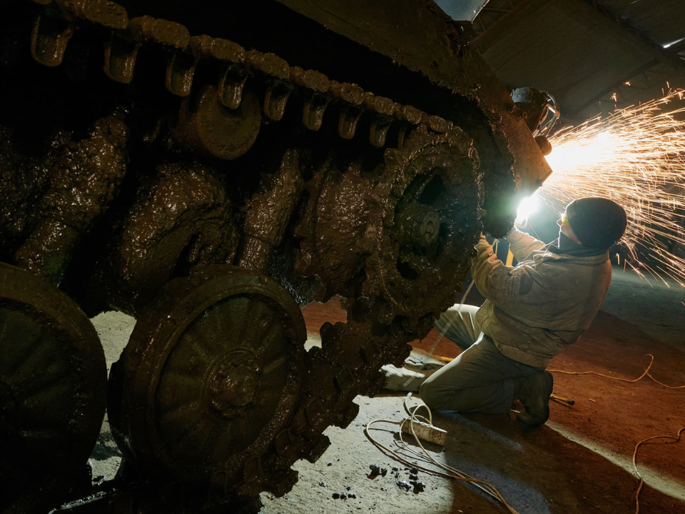 Ukrainian soldiers repairing armored vehicles near Donetsk front line.