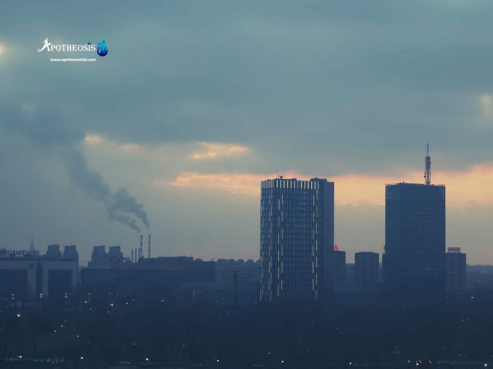 City skyline at dusk with smokestacks emitting pollution, symbolizing the call for rethinking air