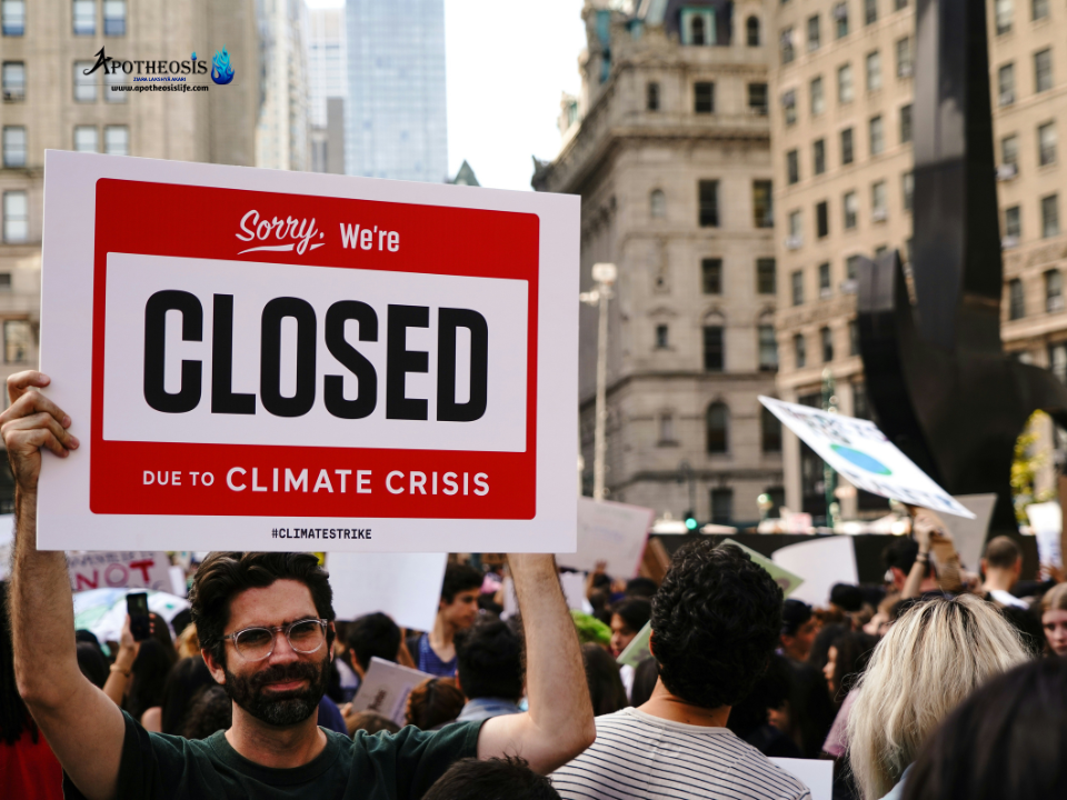 Crowd at a climate strike holding a sign about the climate crisis, symbolizing public demand for Corporate Climate Action.